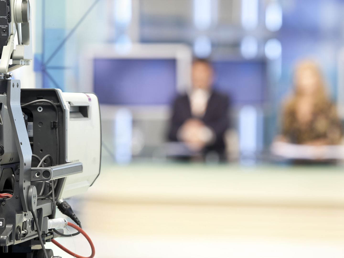 Two newsreader in front of television camera