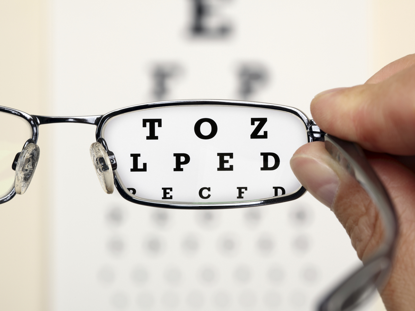 Looking through glasses at an eye exam chart