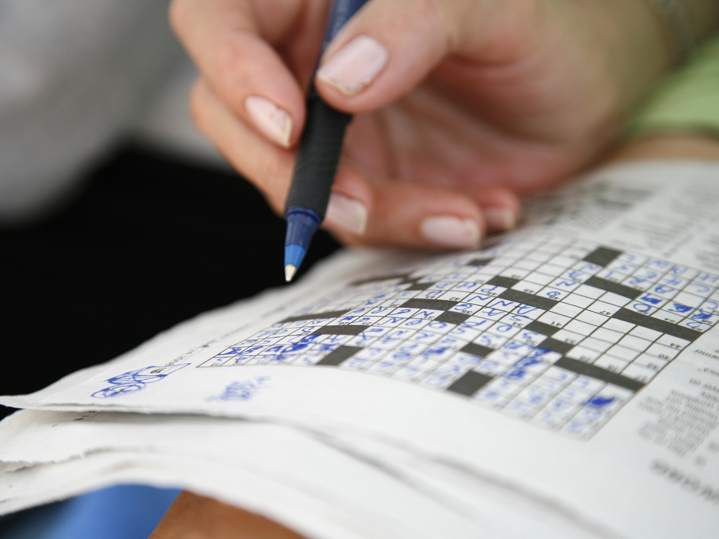 Working on a crossword puzzle.