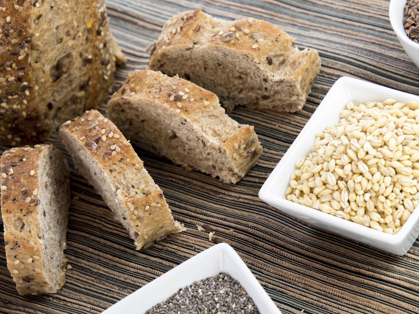 a fresh baked loaf of whole grains bread with poppy, flax adn sunflower seeds