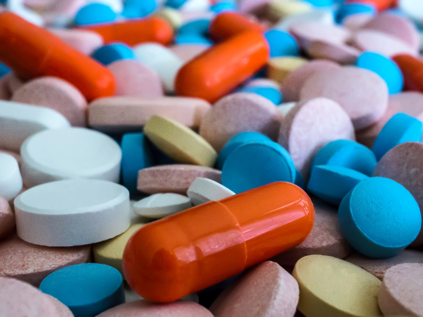 Heap of medicine pills. Close up of colorful tablets and capsules.