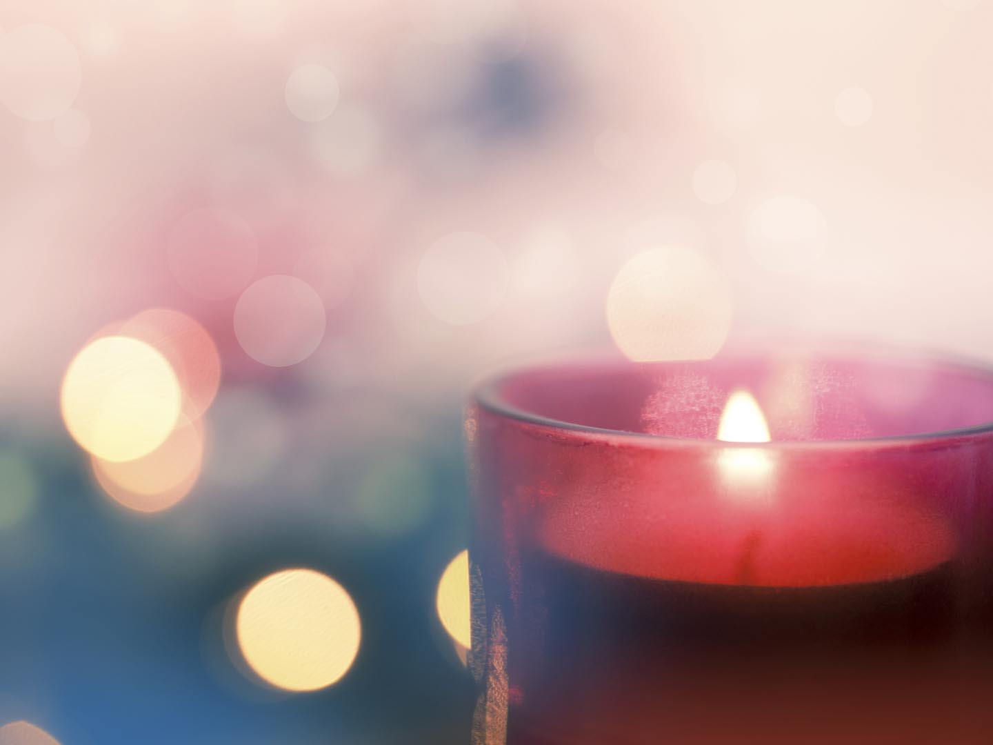 Candle with pink and blue bokeh background