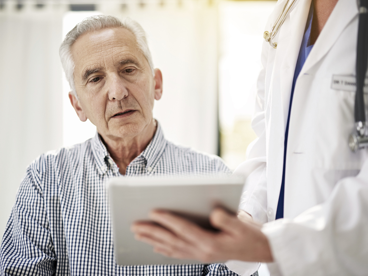 Shot of a doctor showing a senior patient some information on a digital tablet in her office