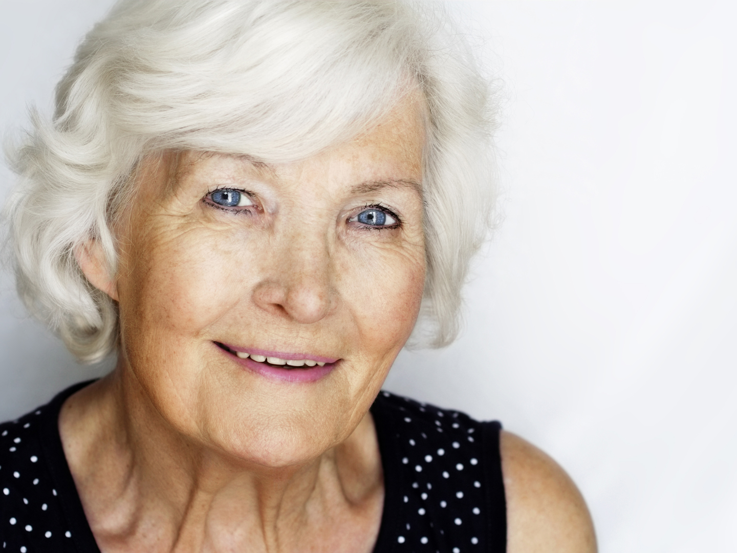 Beautiful senior woman portrait, outdoor on grey background