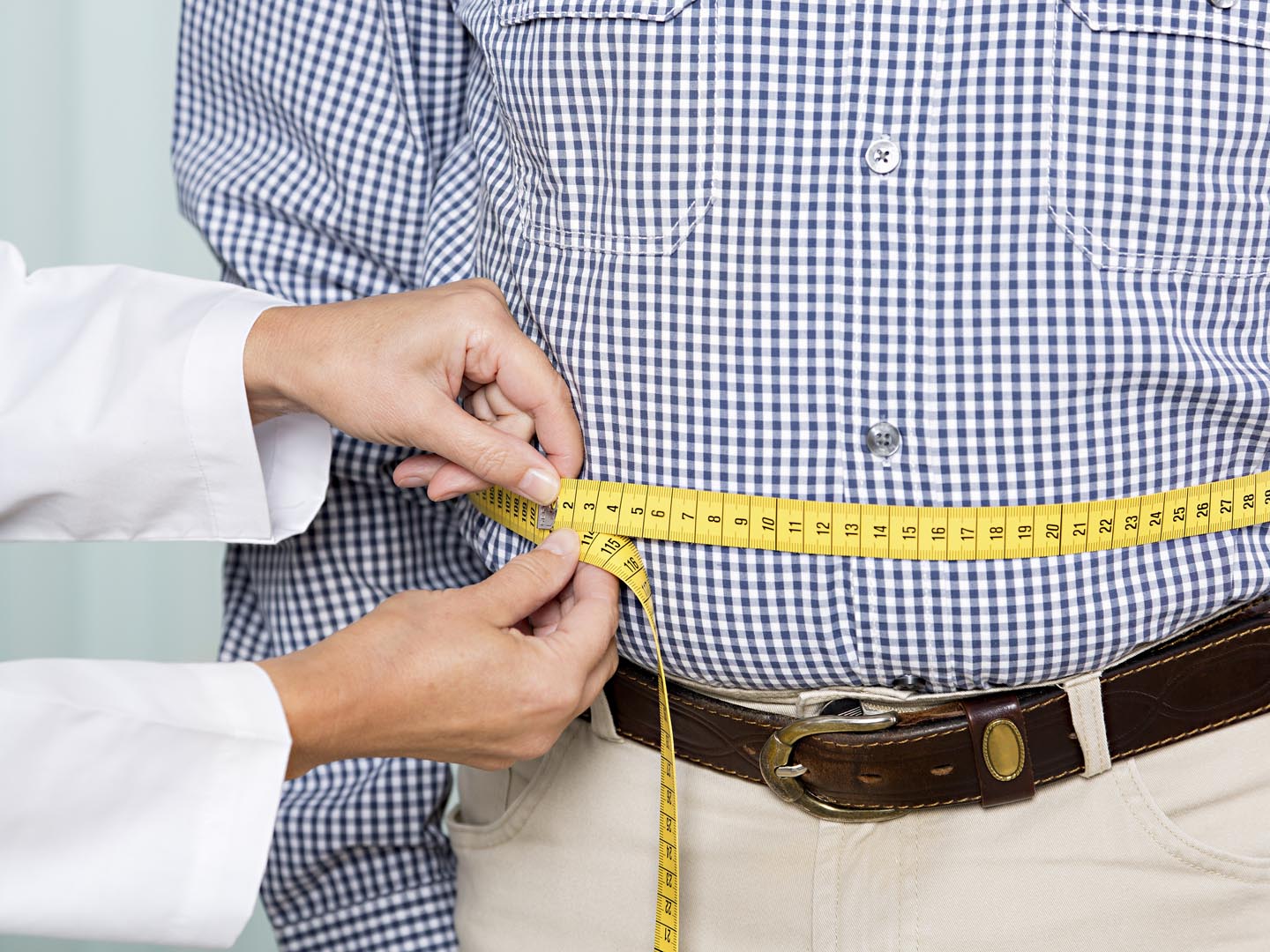 Medical examination: doctor measures overweight