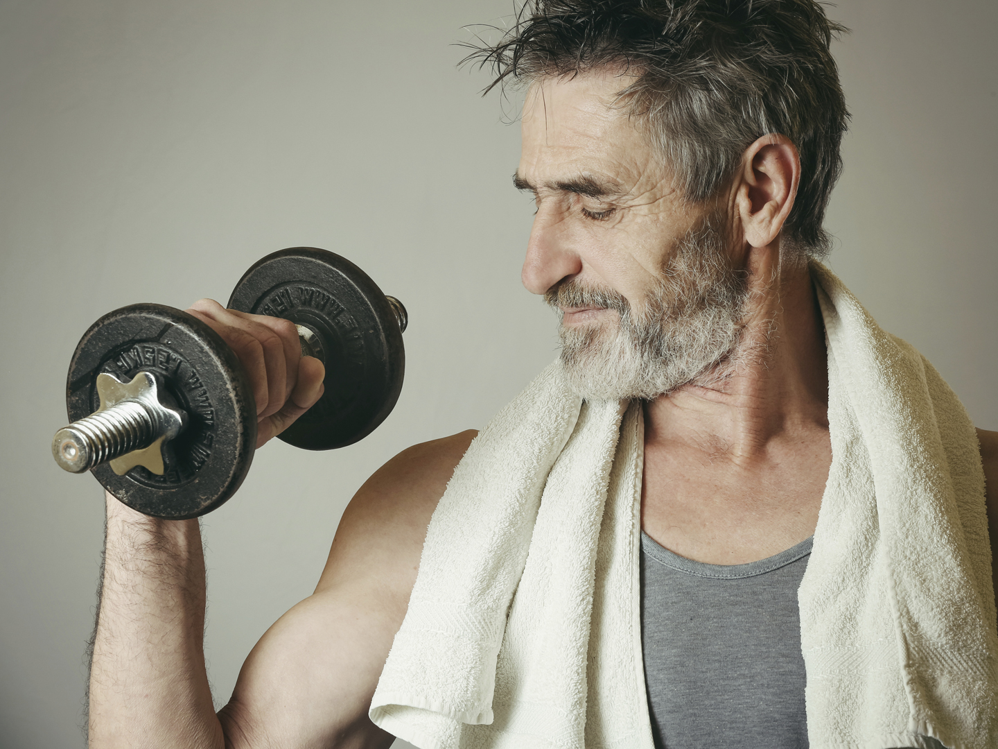 Senior man lifting weights