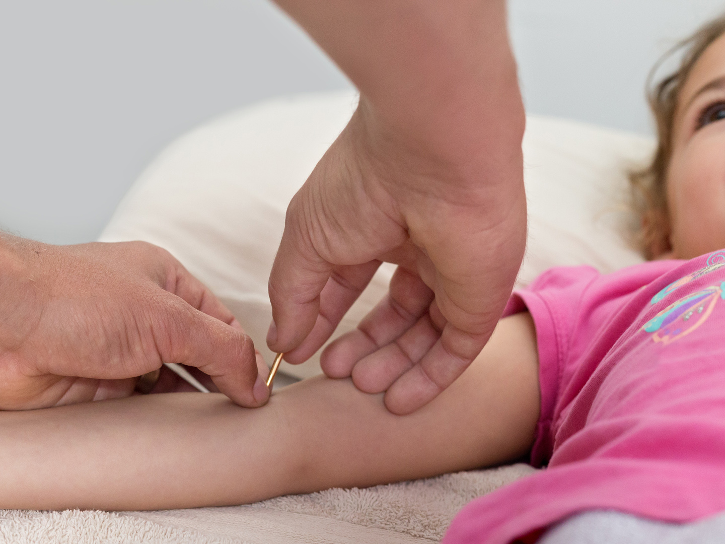 Child having points stimulated during an Acupuncture Session.  The style being used was Japanese Acupuncture called Toyohari.  The tool in the picture is called Teishin.