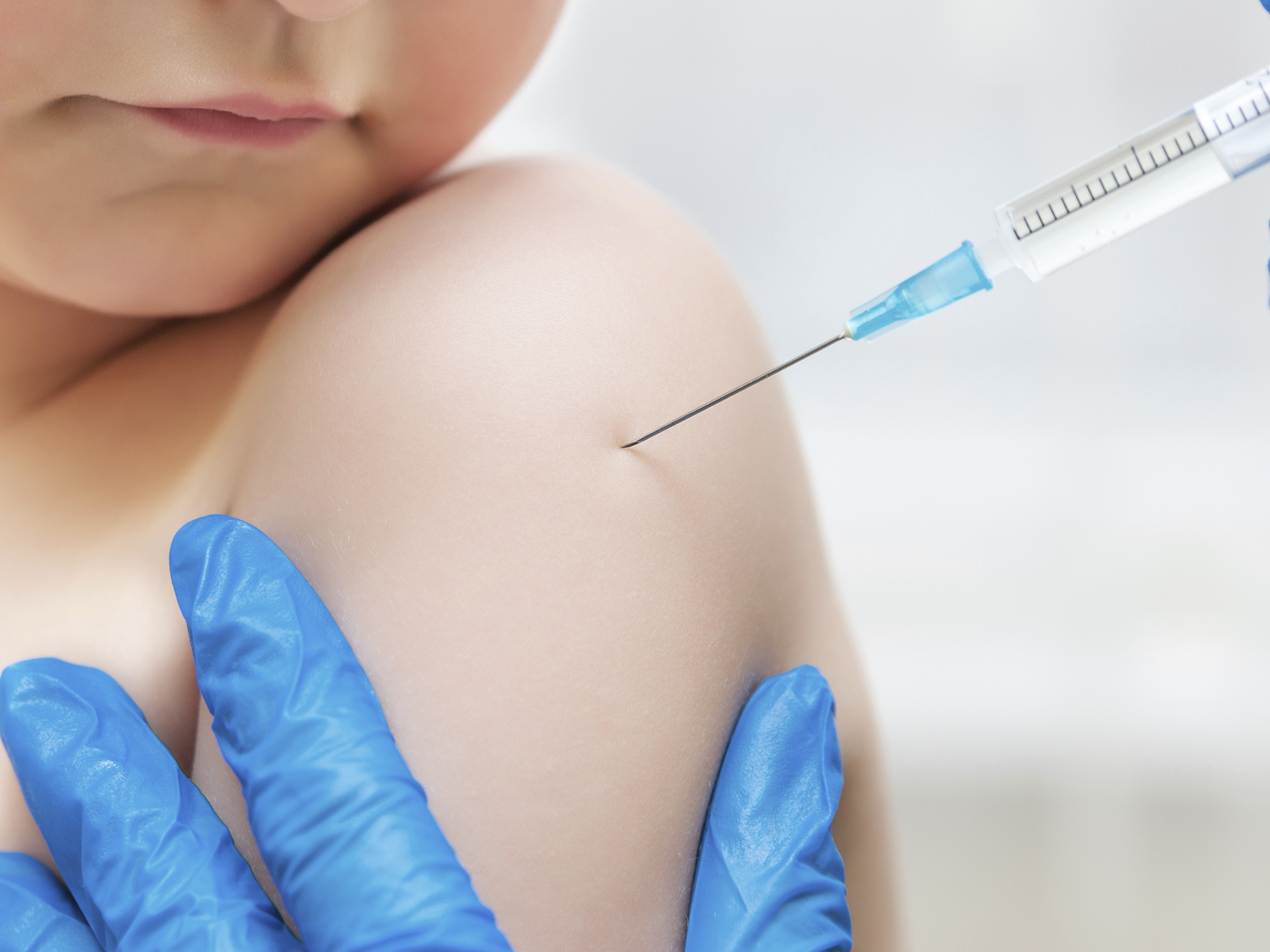 Boy and vaccine syringe