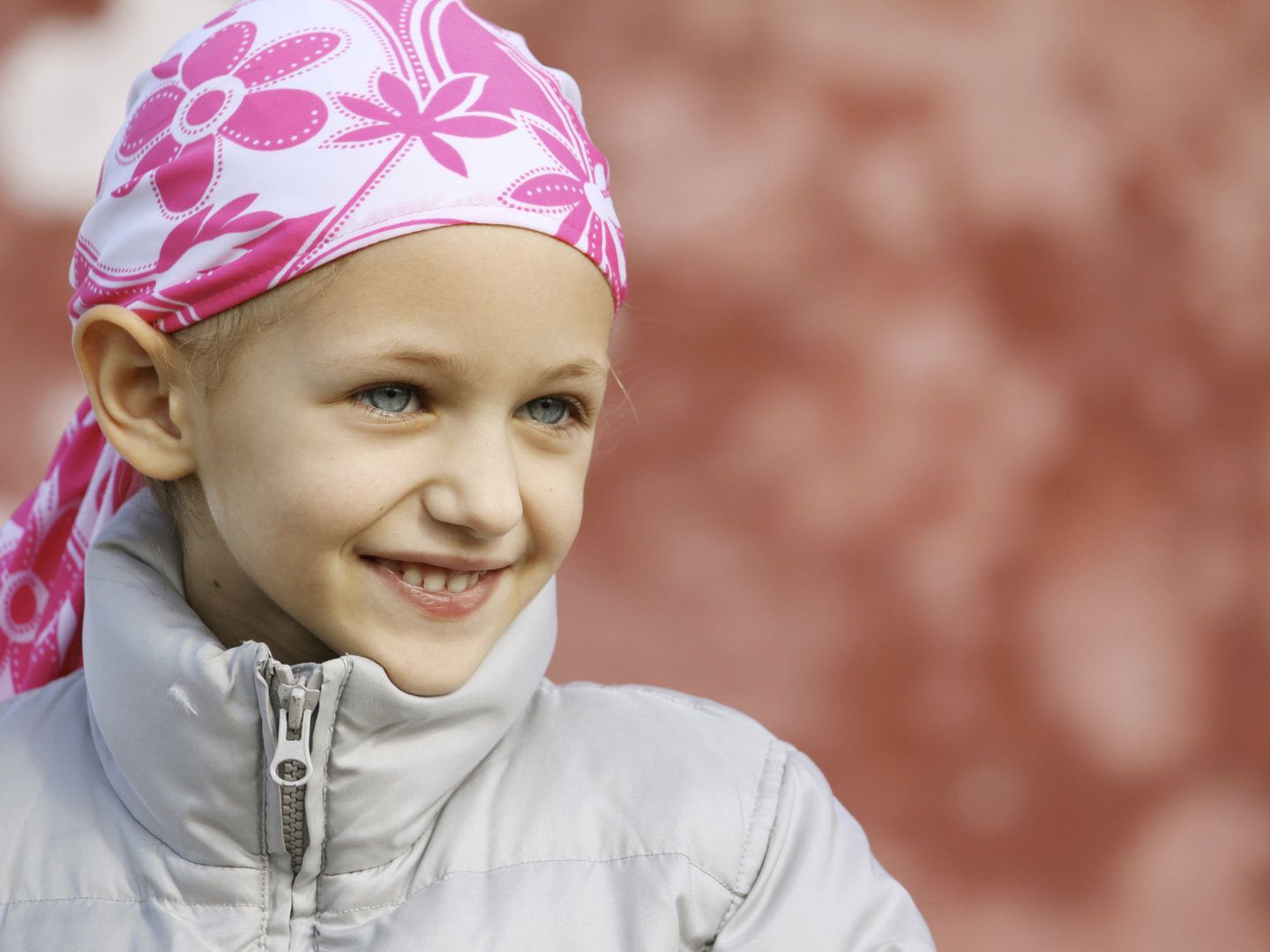 beautiful caucasian girl wearing a head scarf due to hair loss from chemotherapy fighting cancer