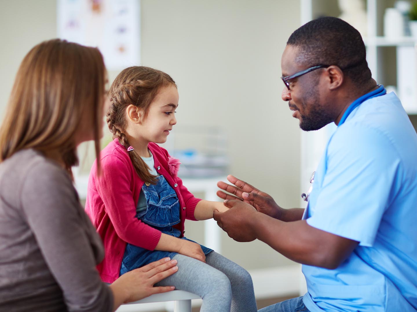 Doctor in surgery examining little girl