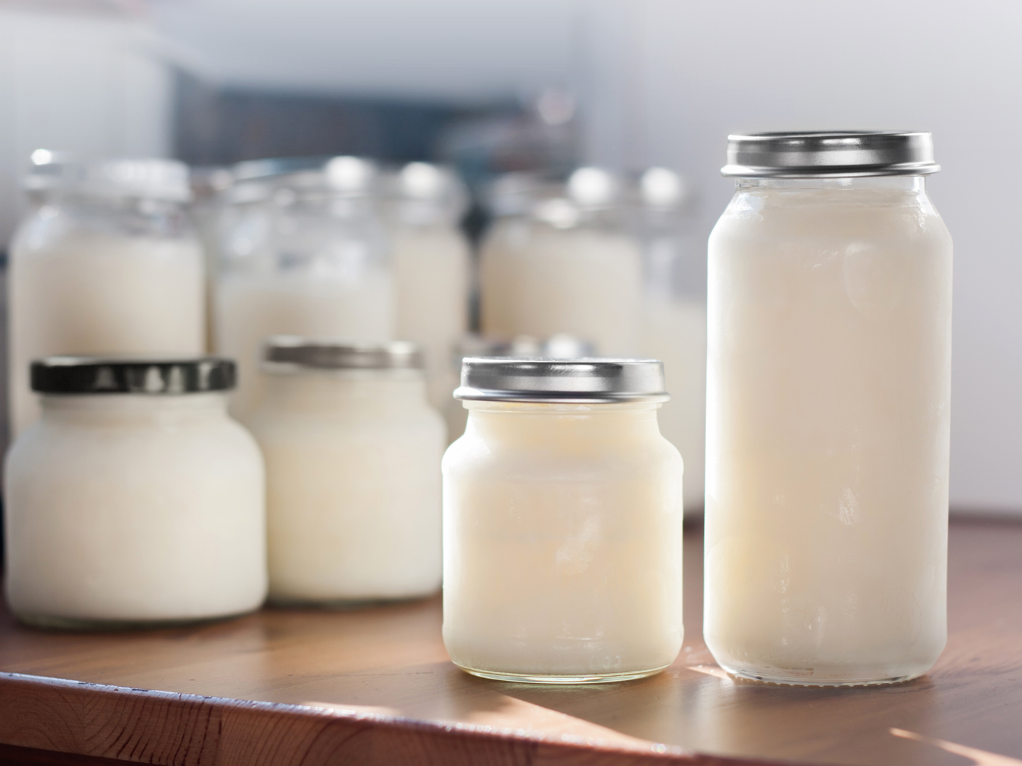 Storing breast milk. Frozen breast milk in  bottles of glasses just taken out of the freezer.