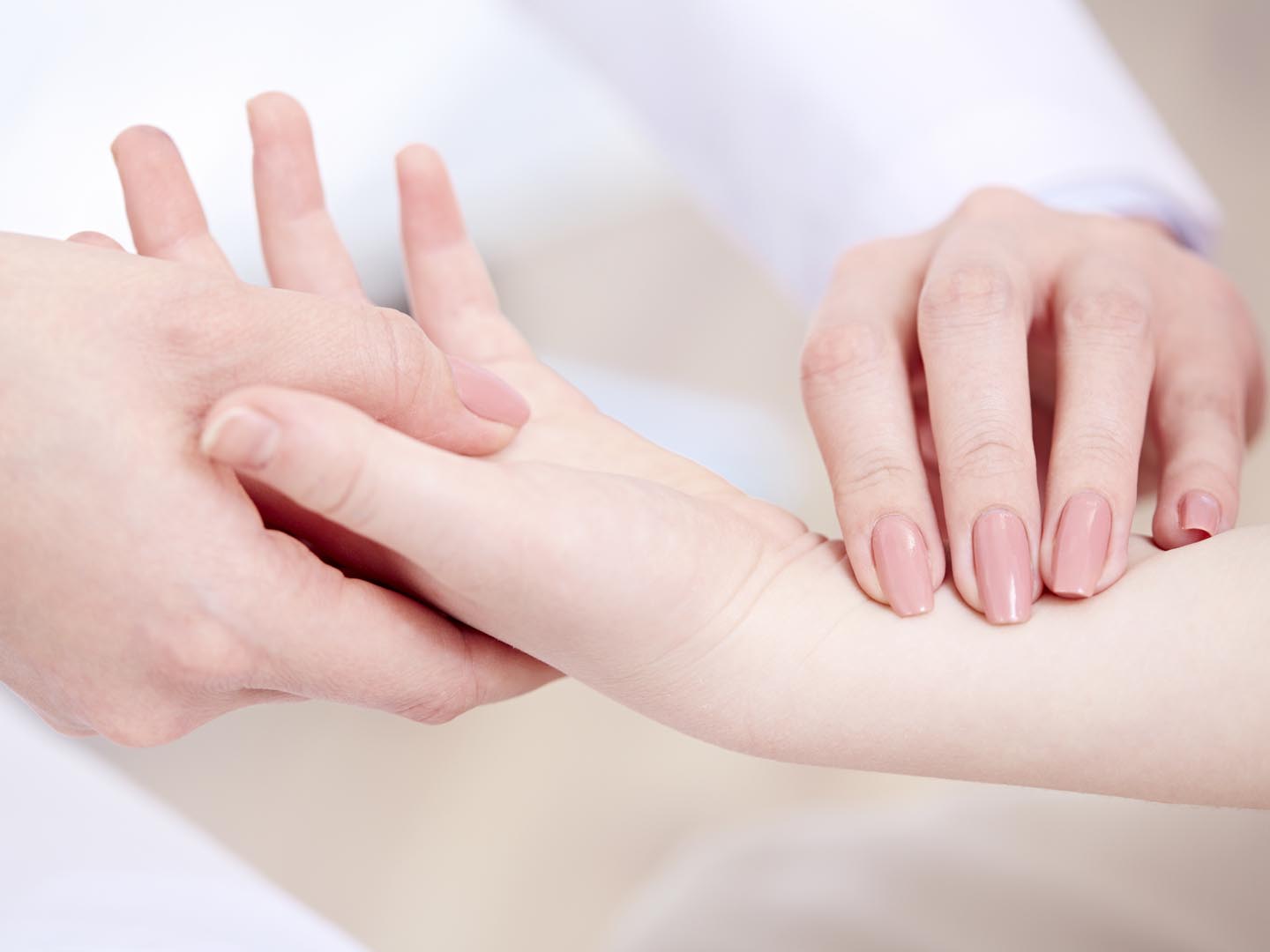 Pediatrician checking child’s wrist