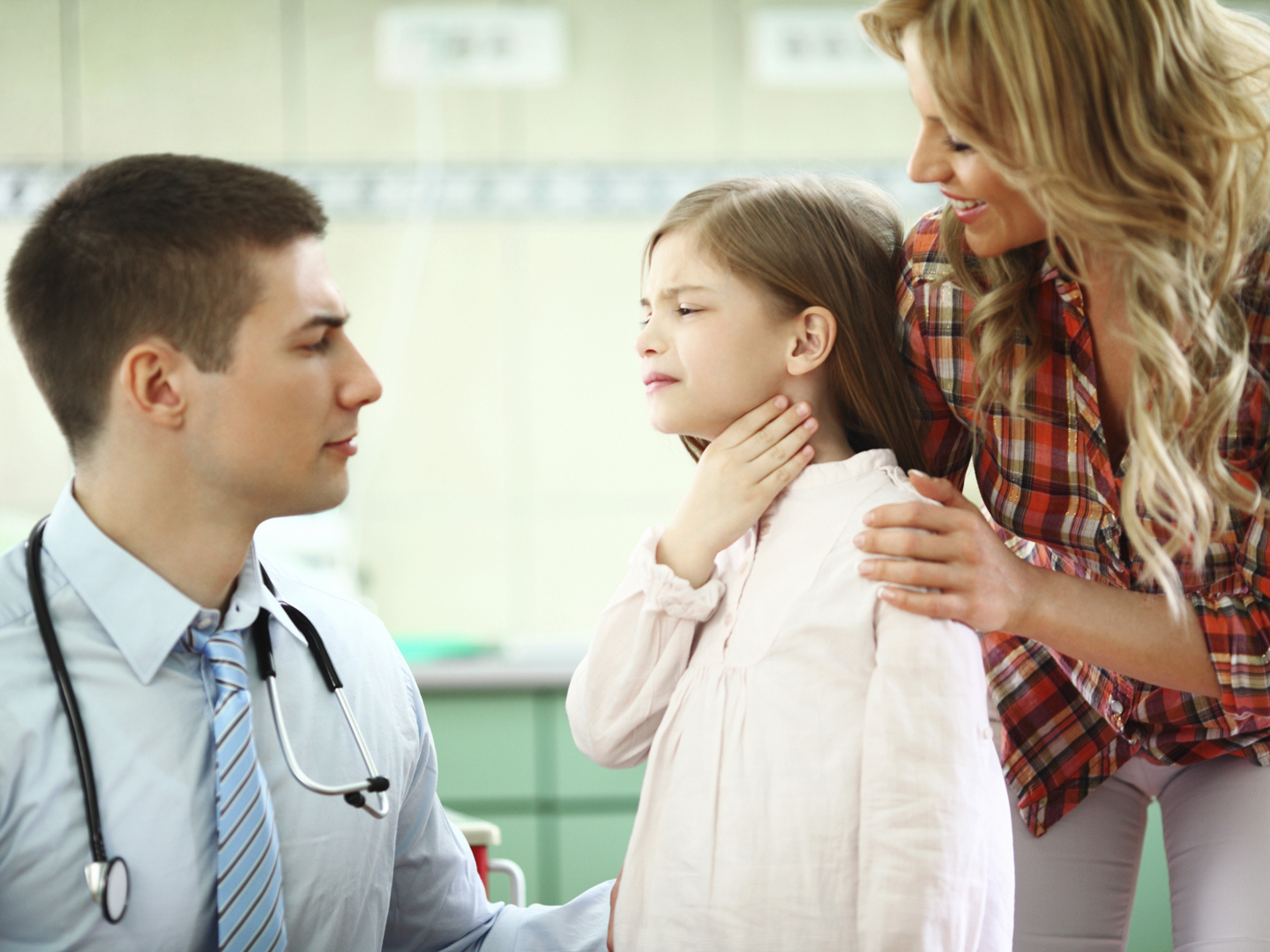 Little girl with her mother visiting pediatrician.