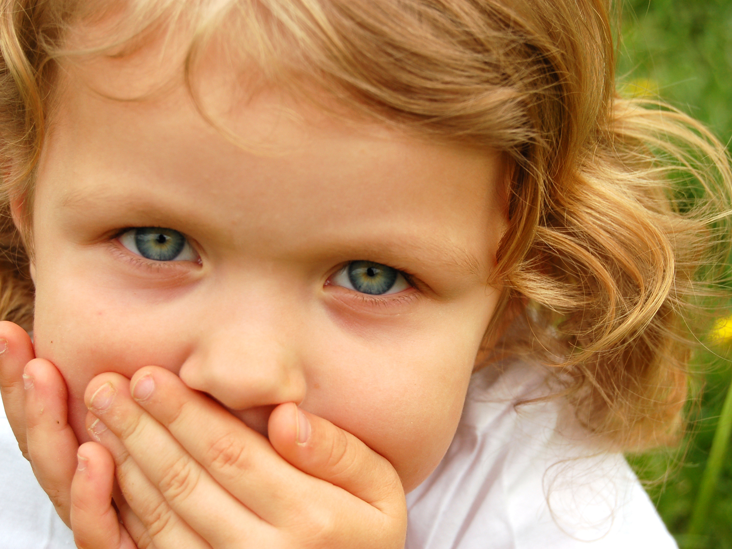 portrait of small pretty girl with curly hair and blue eyes