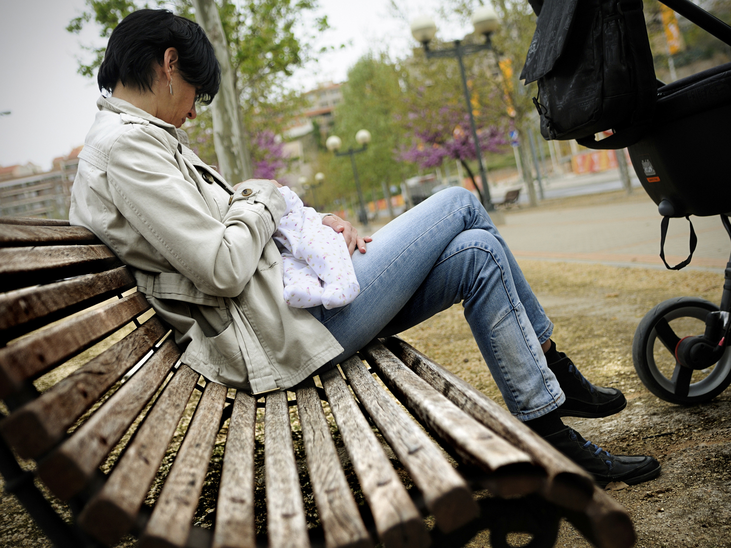 Mother breastfeeding her baby in the street