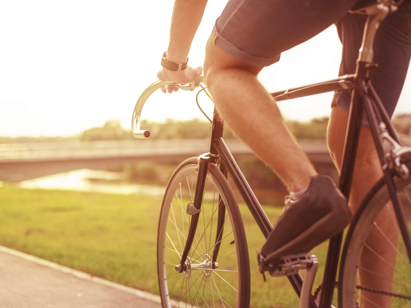 Hipster on bike in the city at sunset. Without face