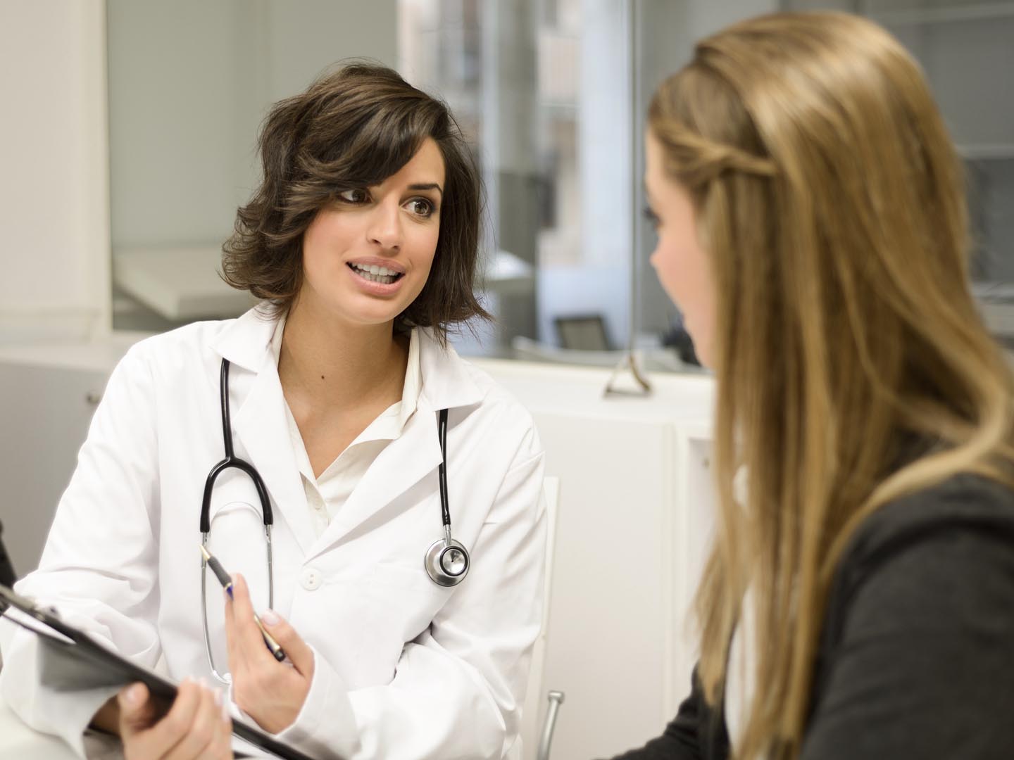 Female doctor explaining diagnosis to her female patient