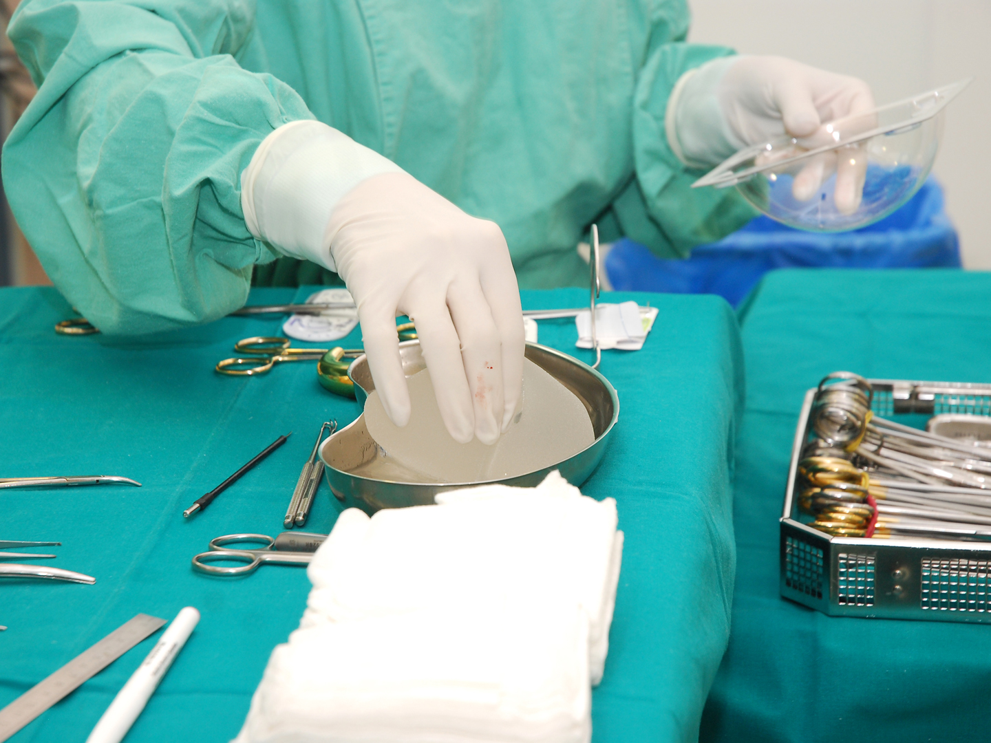 Nurse with operating tools and chest implants