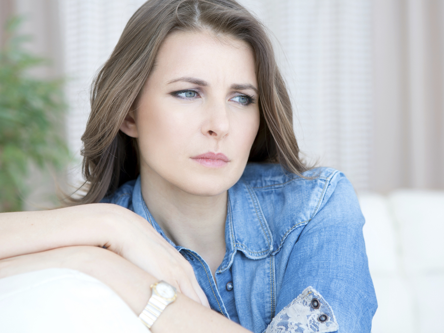 Upset mid-age woman sitting indoors..See more LIFESTYLE images with this MID-AGE WOMAN. Click on any image below for lightbox.