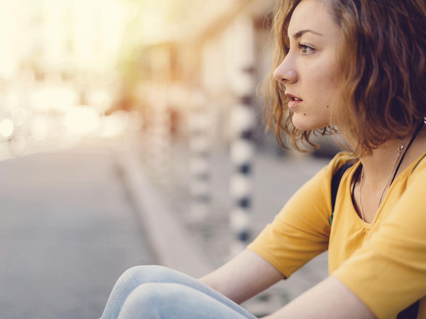 Teenage girl staring at the street