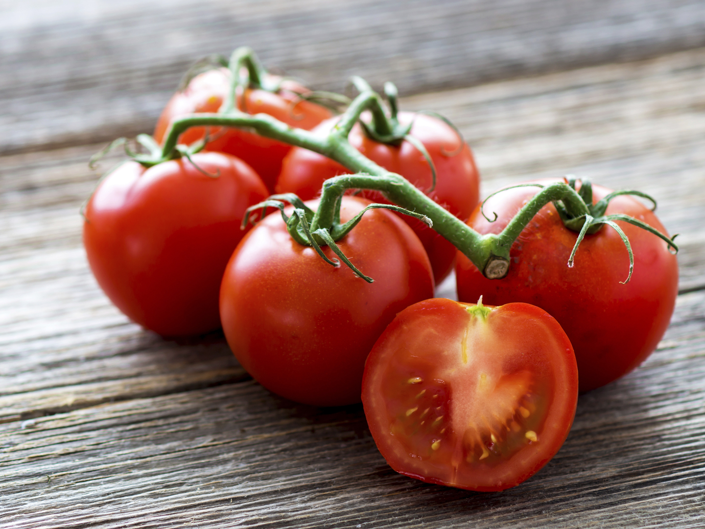 Fresh tomatoes on wood background