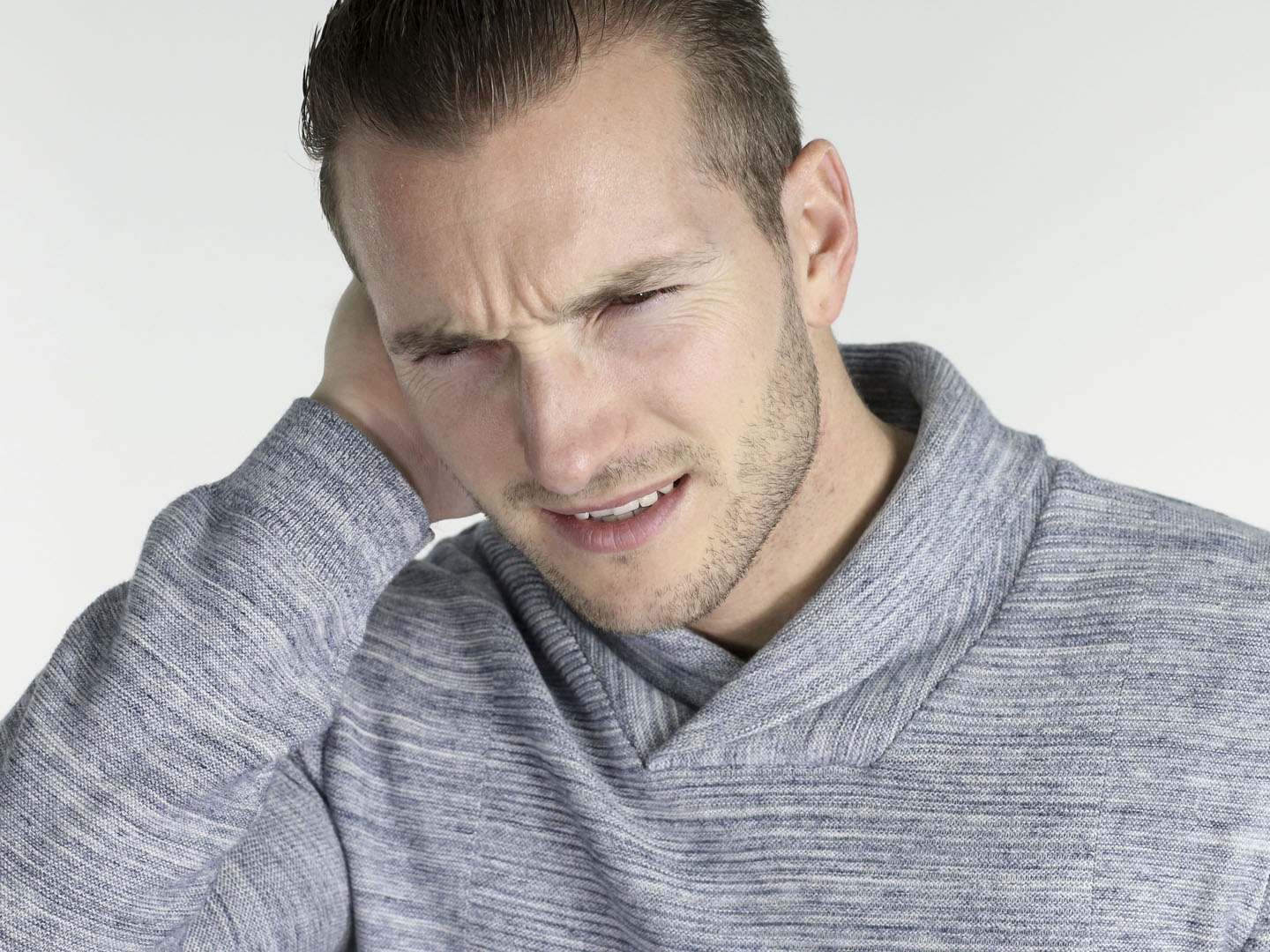 Young man with an ear infection over a white background