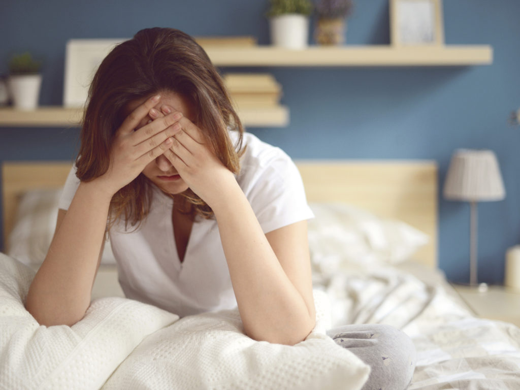 Unhappy girl in a bedroom