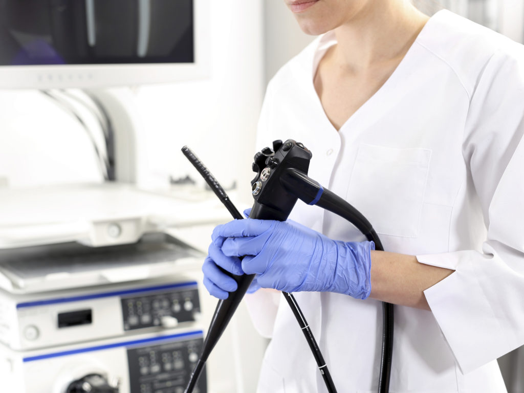 Doctor gastroenterologist with probe to perform gastroscopy and colonoscopy