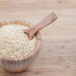 these herbs are quinoa in an wooden bowl with spoon