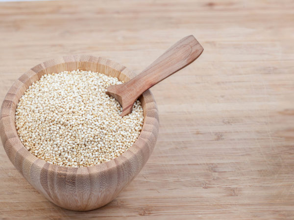 these herbs are quinoa in an wooden bowl with spoon