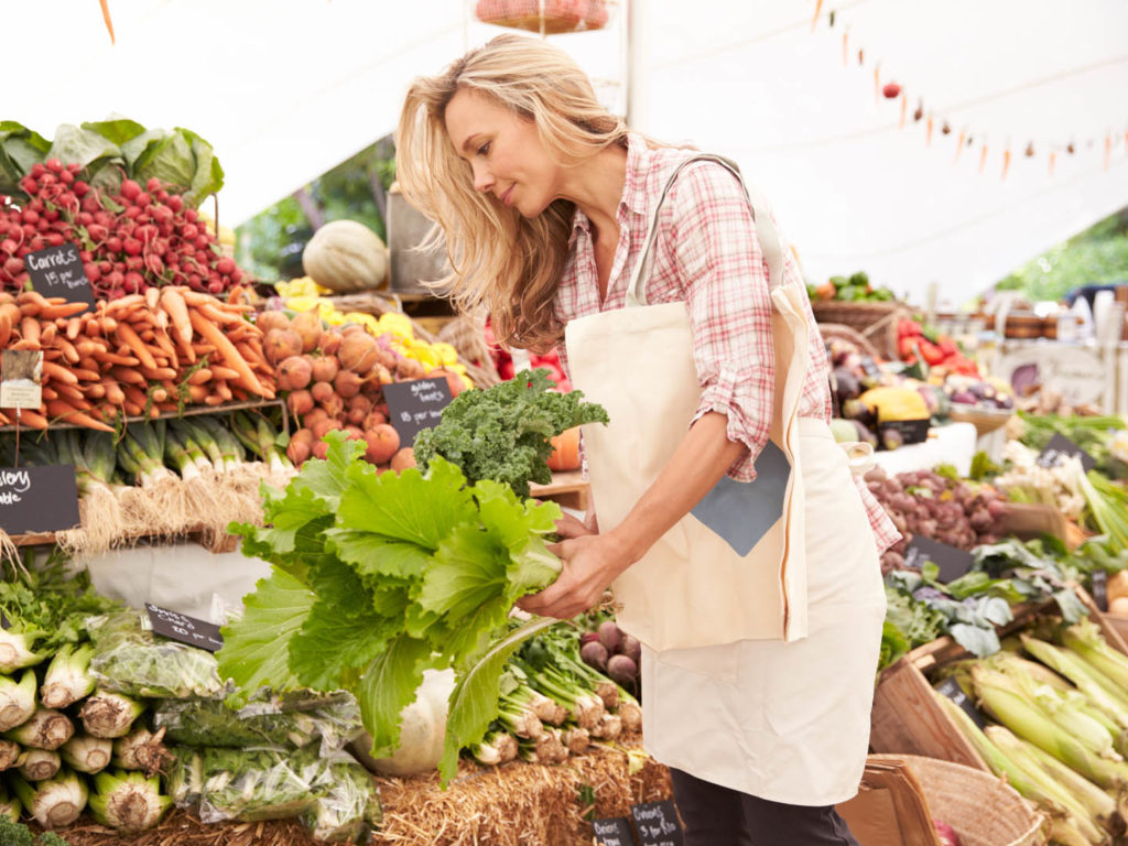 Female Customer Shopping At Farmers Market Stall