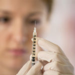 Woman doctor and syringe