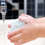 Detail of little girl washing her hands