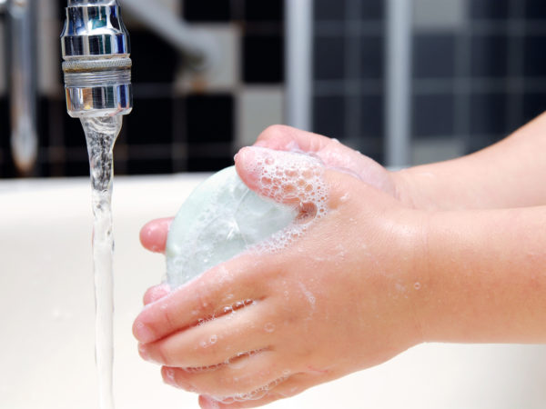 Detail of little girl washing her hands