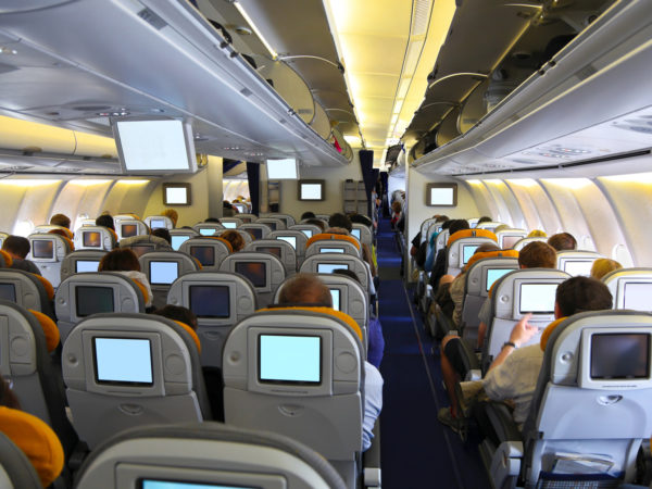 Passengers watching movie in the airplane over the sea