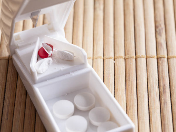 Pill splitter used to cut medicine in half to control dosage.