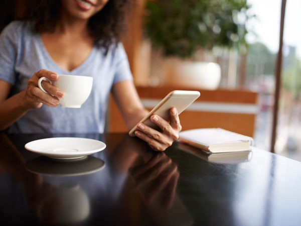 Woman checking social media on her smartphone, selective focus