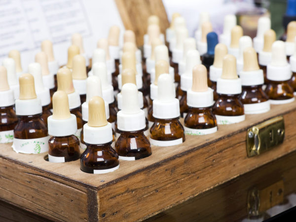 A wooden box of flower extracts for the preparation of Bach Flowers remedies. The bottle labels have the scientific name of the plant.