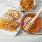 Still life with honey, honeycomb, pollen