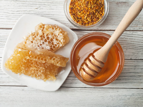 Still life with honey, honeycomb, pollen