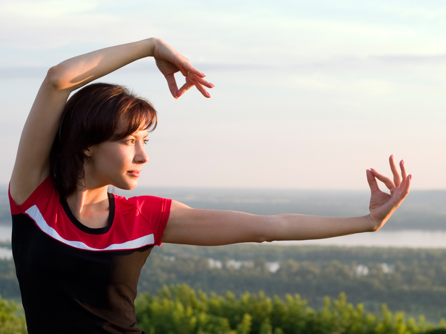 young beautiful girl have some exercises in the meadow