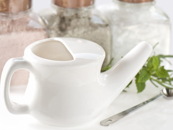 Neti pot for sinus health with salts of different colors and herbs for Ayurvedic technique to administer saline.