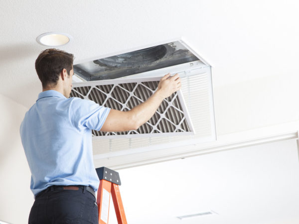 Man cleaning air ducts in home.