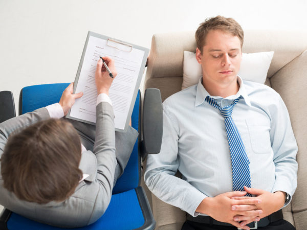 Young businessman having consultation with the psychologist, view from the top