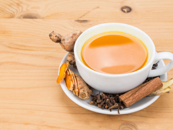 Aromatic turmeric tea with black pepper, cinnamon, cloves and ginger offers many wellness health benefits