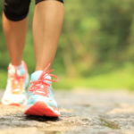 fitness woman hiker feet hiking on stone trail