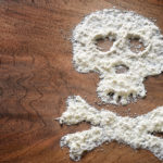 Drug powder cocaine in silhouette of the skull