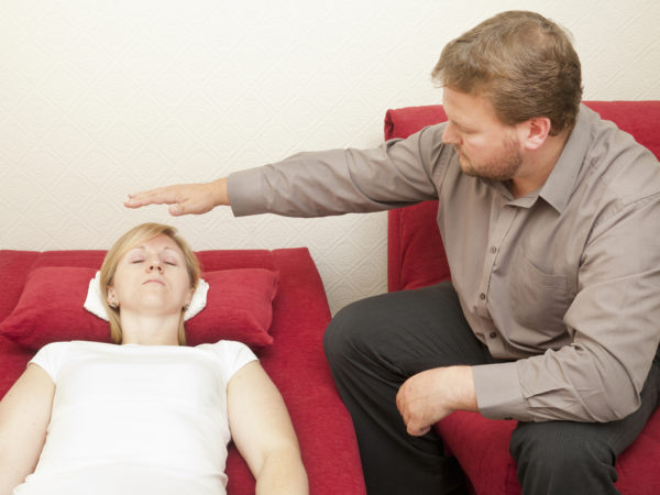 A male hypnotist working with a female patient.For similar images visit my Counselling &amp; Hypnotherapy Lightbox