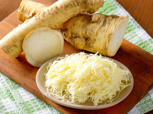 horseradish on wooden cutting board and dishtowel