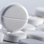 Several tablets or pills on a white background